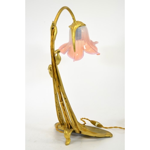 248 - An Art Nouveau gilt bronze desk lamp, circa 1900, in the form of a flower, the sinuous three tendril... 