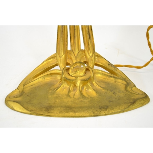 248 - An Art Nouveau gilt bronze desk lamp, circa 1900, in the form of a flower, the sinuous three tendril... 