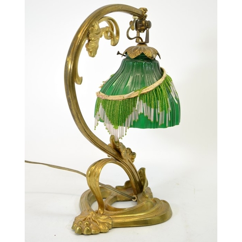 252 - An Art Nouveau gilt bronze table lamp, circa 1900, sinuous tendril design with cast leaves and berri... 