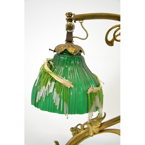 252 - An Art Nouveau gilt bronze table lamp, circa 1900, sinuous tendril design with cast leaves and berri... 