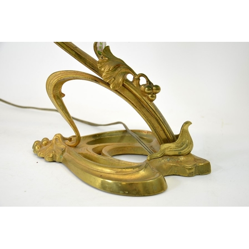 252 - An Art Nouveau gilt bronze table lamp, circa 1900, sinuous tendril design with cast leaves and berri... 