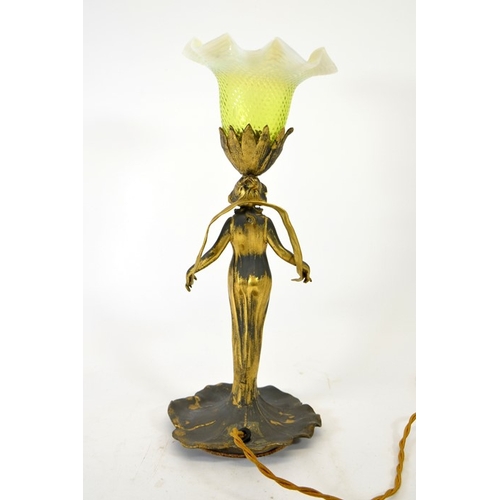 256 - An Art Nouveau gilt metal figural table lamp, circa 1900, modelled as a woman holding a strand of gr... 