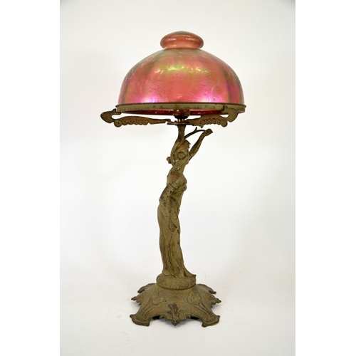 266 - An Art Nouveau figural table lamp with Loetz type iridescent glass dome shade, circa 1900, papillon ... 