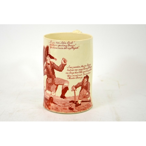 988 - A Napoleonic creamware cartoon mug, circa 1790-1810, red transfer printed decoration of Napoleon and... 