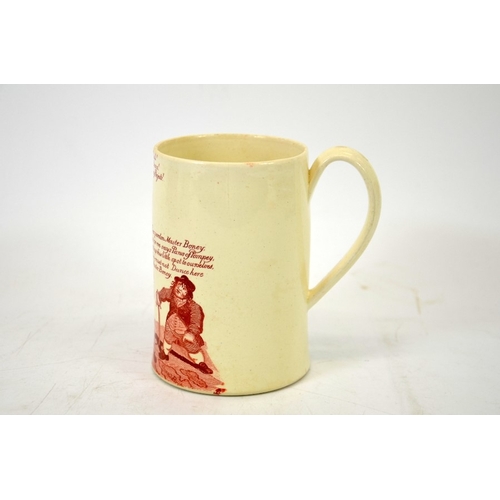 988 - A Napoleonic creamware cartoon mug, circa 1790-1810, red transfer printed decoration of Napoleon and... 