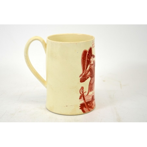 988 - A Napoleonic creamware cartoon mug, circa 1790-1810, red transfer printed decoration of Napoleon and... 