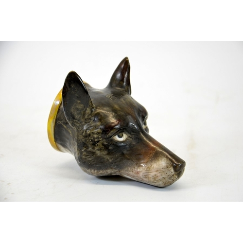 991 - A 19th century porcelain stirrup cup, modelled as a fox head, 12cm high