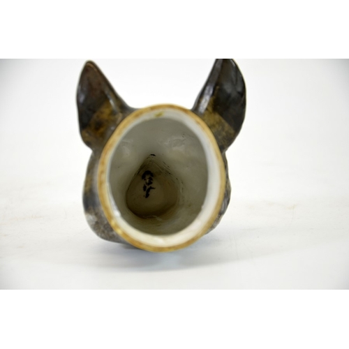 991 - A 19th century porcelain stirrup cup, modelled as a fox head, 12cm high