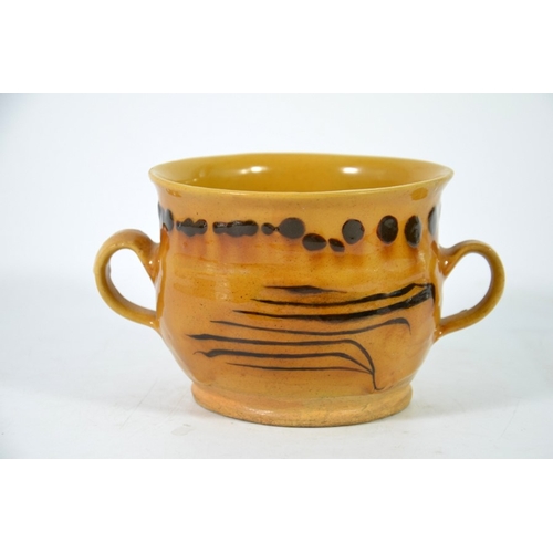 992 - An English slipware lowing cup, twin handled ogee form with dot and stripe decoration, circa 1750, 1... 