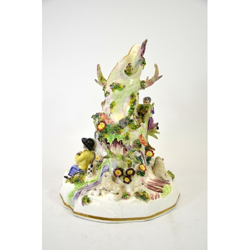 994 - A Staffordshire porcelain figure group, modelled as a tree stump with shepherd and sheep, child harv... 