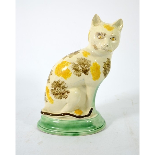 995 - A Staffordshire pottery figure of a cat, circa 1785, sponge decorated, in sitting position, 22cm hig... 