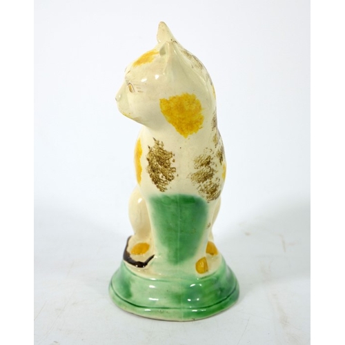 995 - A Staffordshire pottery figure of a cat, circa 1785, sponge decorated, in sitting position, 22cm hig... 