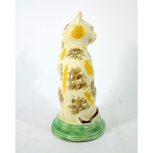 995 - A Staffordshire pottery figure of a cat, circa 1785, sponge decorated, in sitting position, 22cm hig... 