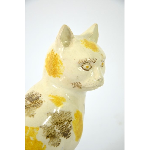 995 - A Staffordshire pottery figure of a cat, circa 1785, sponge decorated, in sitting position, 22cm hig... 