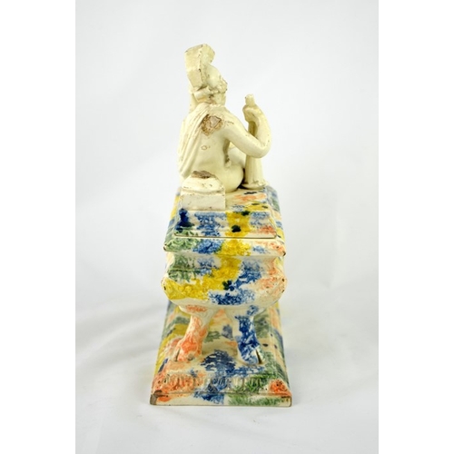 997 - A 19th century Prattware ink stand, sarcophagus form, the lid with a reclining Classical figure of a... 