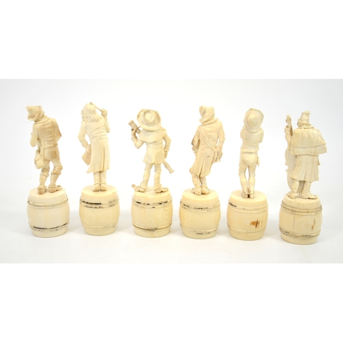 24 - λ A group of six 19th century Dieppe carved ivory figures of a musical band, stood on barrels, 15cm ... 