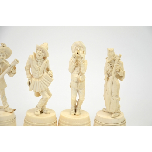 24 - λ A group of six 19th century Dieppe carved ivory figures of a musical band, stood on barrels, 15cm ... 