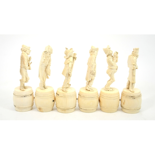 24 - λ A group of six 19th century Dieppe carved ivory figures of a musical band, stood on barrels, 15cm ... 