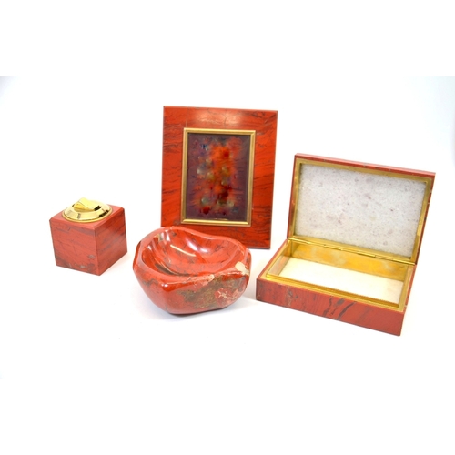 88 - An Asprey red jasper desk set, circa 1960s, including an ash tray, table lighter, photograph frame a... 