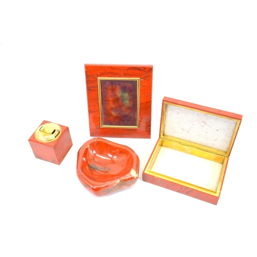 88 - An Asprey red jasper desk set, circa 1960s, including an ash tray, table lighter, photograph frame a... 