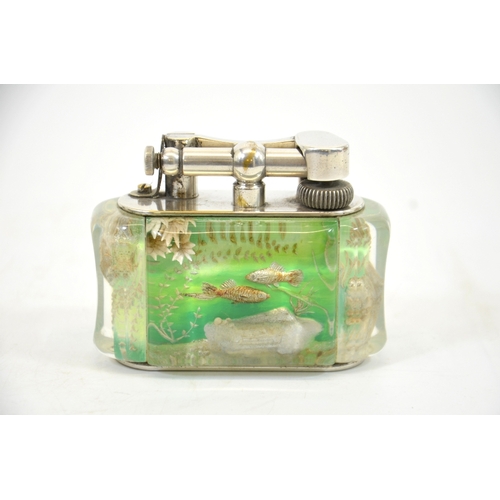 89 - Ben Shillingford for Alfred Dunhill, an Aquarium table lighter, half giant, reverse carved and paint... 