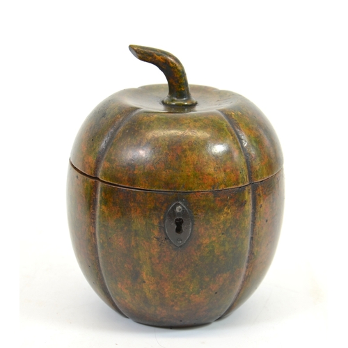 106 - A George III fruitwood melon form tea caddy, with white metal escutcheon, lobed ovoid form with stem... 