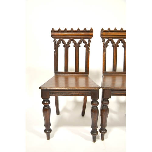 123 - A set of four William IV Gothic Revival oak hall chairs, circa 1835, octagonal baluster legs support... 