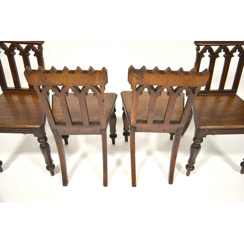 123 - A set of four William IV Gothic Revival oak hall chairs, circa 1835, octagonal baluster legs support... 