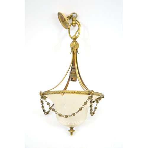 242 - An Edwardian brass and glass pendant light fitting, with domed and star cut frosted shade,