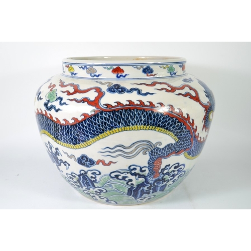 4 - A Chinese polychrome jardiniere, squat ovoid form with single dragon amongst clouds, underglaze blue... 