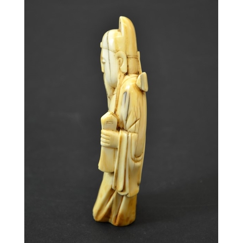 52 - A Chinese carved walrus ivory figure of an immortal, 19th century or earlier, 11cm long