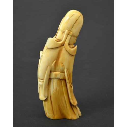 52 - A Chinese carved walrus ivory figure of an immortal, 19th century or earlier, 11cm long