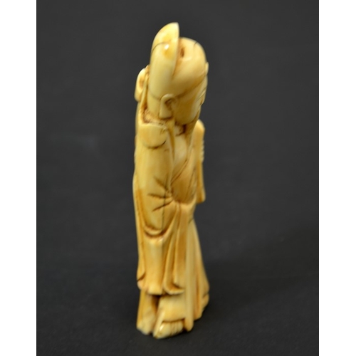 52 - A Chinese carved walrus ivory figure of an immortal, 19th century or earlier, 11cm long