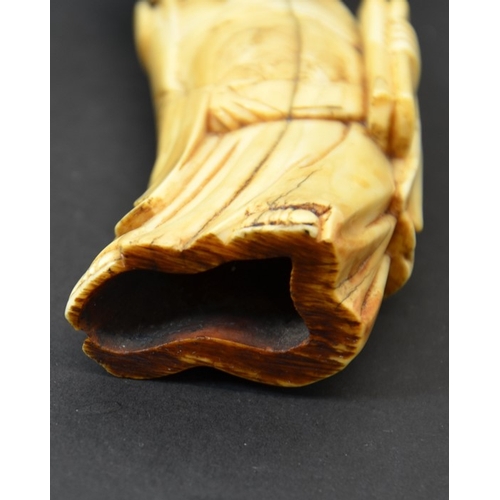 52 - A Chinese carved walrus ivory figure of an immortal, 19th century or earlier, 11cm long