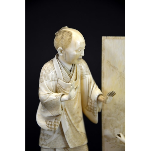 59 - λ A 19th century Japanese carved ivory okimono, Meiji, modelled as an art student and teacher, the c... 