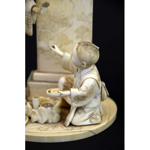 59 - λ A 19th century Japanese carved ivory okimono, Meiji, modelled as an art student and teacher, the c... 