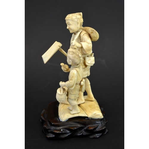 62 - λ A 19th century Japanese carved ivory okimono, Meiji, modelled as an elderly farmer and boy, carryi... 