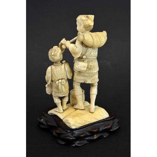 62 - λ A 19th century Japanese carved ivory okimono, Meiji, modelled as an elderly farmer and boy, carryi... 