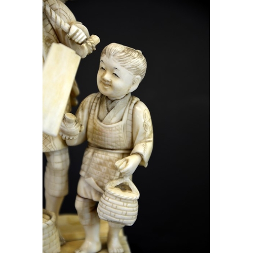 62 - λ A 19th century Japanese carved ivory okimono, Meiji, modelled as an elderly farmer and boy, carryi... 