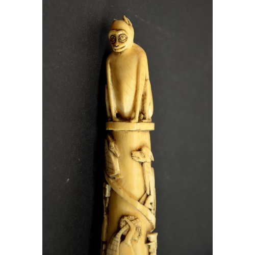 65 - λ A 19th century African tribal carved tusk, decorated with a spiral of African figures in European ... 