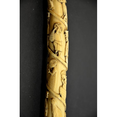 65 - λ A 19th century African tribal carved tusk, decorated with a spiral of African figures in European ... 