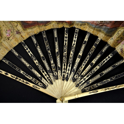 69 - λ A late 18th century hand painted silk and ivory fan, centrally painted with a rustic scene of figu... 