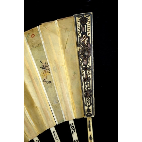 69 - λ A late 18th century hand painted silk and ivory fan, centrally painted with a rustic scene of figu... 