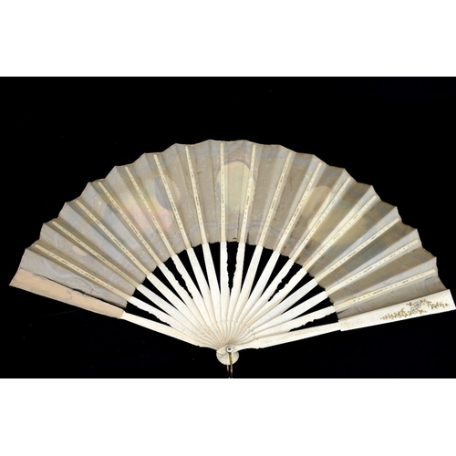 74 - A late 19th/early 20th century fan, the guards and sticks silvered and gilt, the leaf hand painted w... 