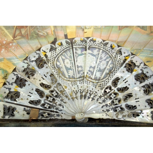 76 - A 19th century mother of pear and silver overlay fan, the leaf painted with 18th century courting sc... 