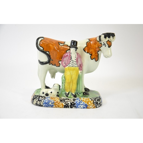 1313 - A Staffordshire prattware figure of a cow, man and dog, circa 1810, 15cm high