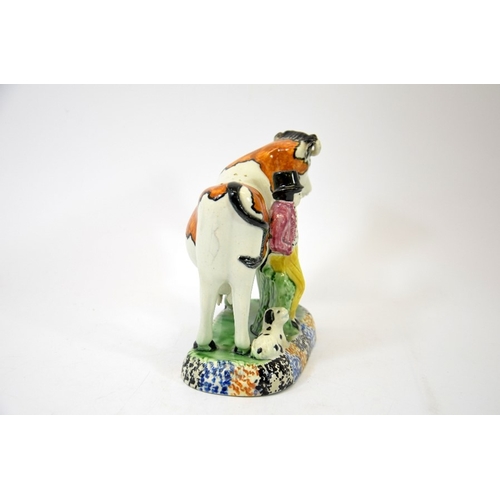 1313 - A Staffordshire prattware figure of a cow, man and dog, circa 1810, 15cm high