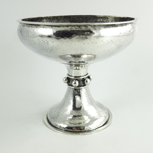 101 - A E Jones, an Arts and Crafts silver tazza or pedestal bowl, Birmingham 1911, planished finish, the ... 