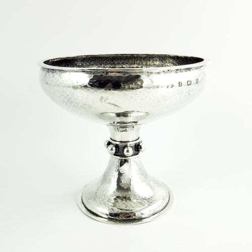 101 - A E Jones, an Arts and Crafts silver tazza or pedestal bowl, Birmingham 1911, planished finish, the ... 