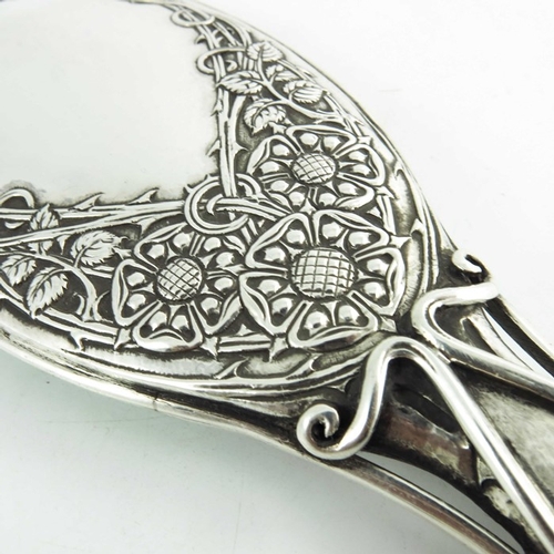 103 - Omar Ramsden and Alwyn Carr, an Arts and Crafts silver hand mirror, London 1915, the oval head embos... 